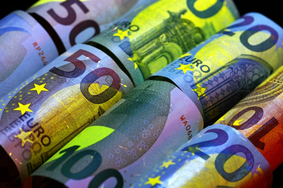 Rolled euro banknotes in various denominations